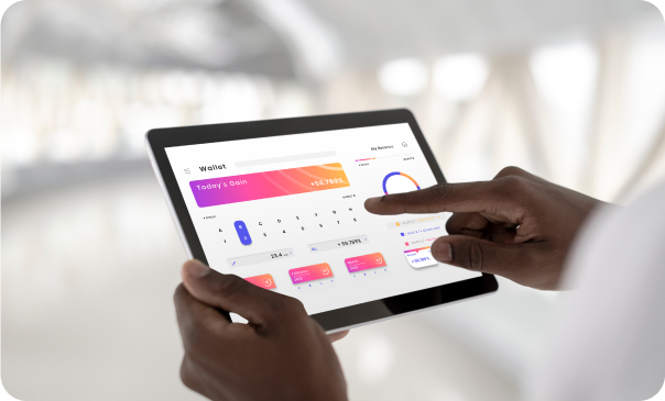 Close-up of hands interacting with a tablet displaying a colorful e-commerce dashboard featuring charts, analytics, and financial data. This image represents Signa Marketing's E-Commerce Website Development services, focusing on creating optimized online shopping experiences, including Shopify stores and custom e-commerce solutions that drive performance and conversions.
