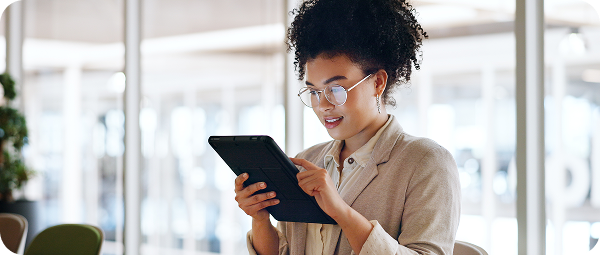 Marketing professional reviewing performance data on a tablet in a modern office